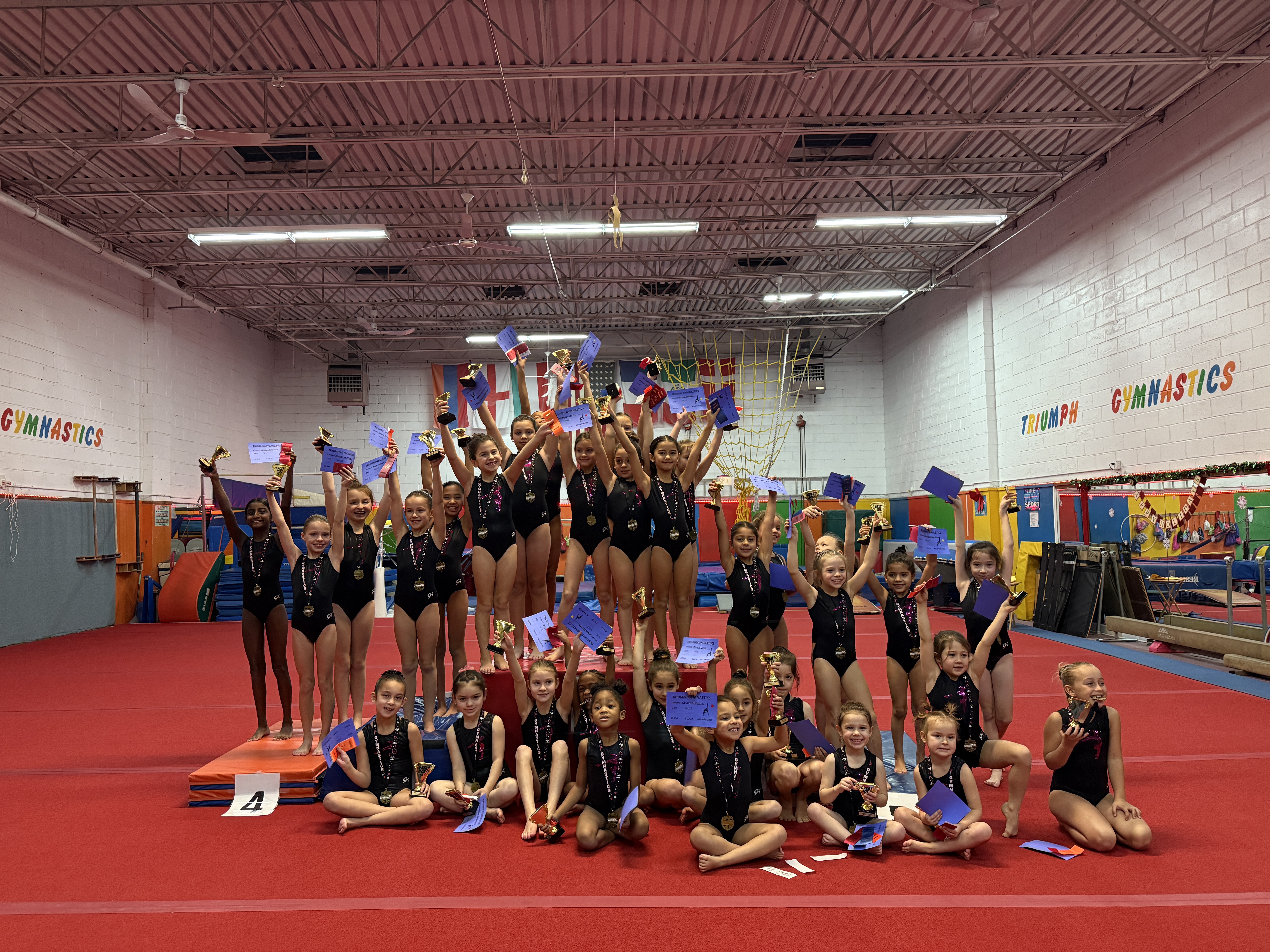 Large team group photo with trophies and medals at competition